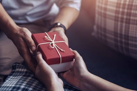 christmas, valentine, holidays gift box concept. Couple surprise gift box together.の写真素材