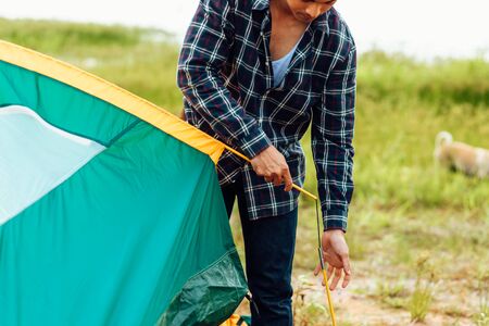 A group of friends traveling and camping near lake and mountain back.の写真素材
