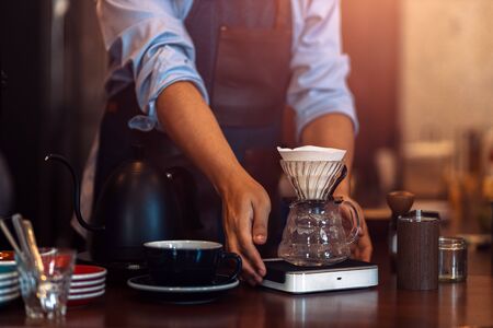 Measuring coffee drip with glass mug の写真素材