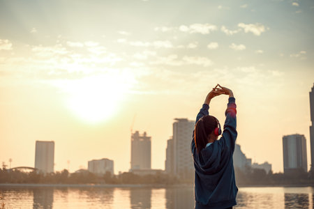 Young woman stretching before doing her workout in the morning.