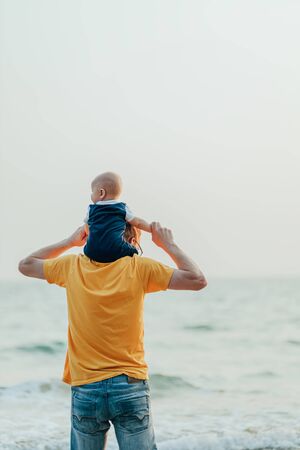 Happy family on the beach.  Father, mother and baby having fun on summer vacation. Holiday travel conceptの写真素材