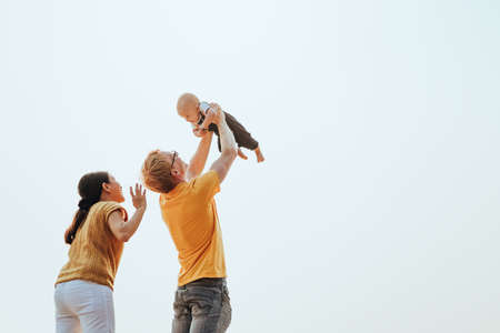 Happy family on the beach.  Father, mother and baby having fun on summer vacation. Holiday travel conceptの写真素材