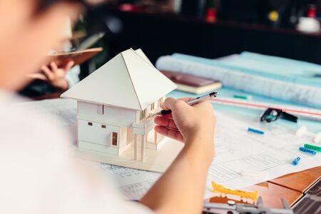 Businessman and architech meeting for planing and checking house design and house model. の写真素材