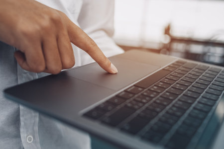 finger's businessman use trackpad on laptop.