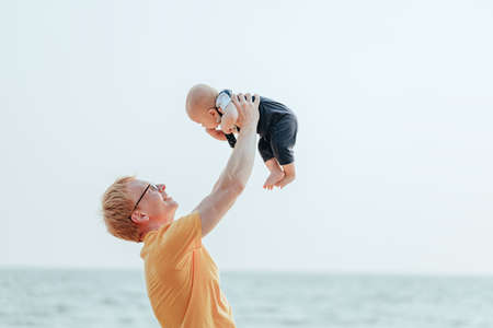 Happy family on the beach.  Father, mother and baby having fun on summer vacation. Holiday travel conceptの写真素材