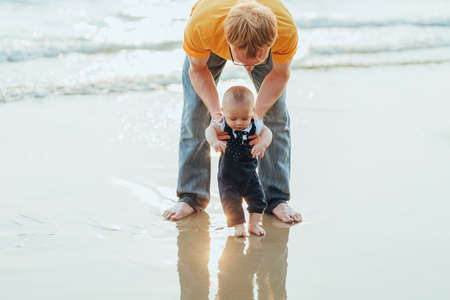 Happy family on the beach.  Father, mother and baby having fun on summer vacation. Holiday travel conceptの写真素材