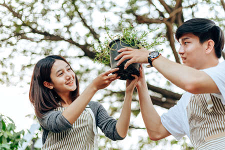 Young couple relax in the garden. They care plant and flower.の写真素材