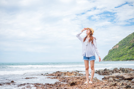 Woman throw cell phone in the beach.