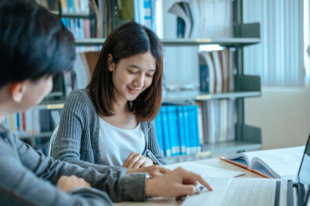 Students studying in the library with laptop at the university. Education concept.の写真素材