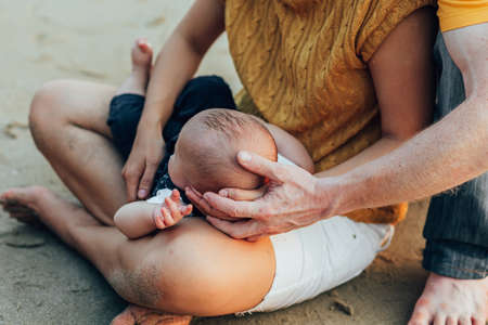 Happy family on the beach.  Father, mother and baby having fun on summer vacation. Holiday travel conceptの写真素材