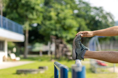 Young man stretching muscles before and after training. Fitness and sport concept.