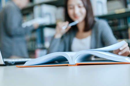 Student open a book and read for exam in the library. Education concept.の写真素材
