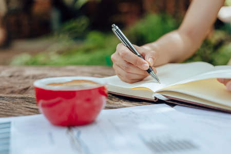 Women writing note book on the table.の写真素材