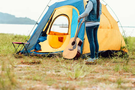 A group of friends traveling and camping near lake and mountain back.の写真素材