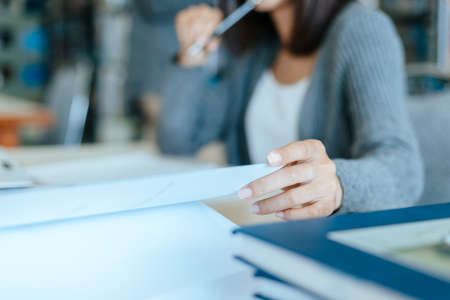Student open a book and read for exam in the library. Education concept.の写真素材