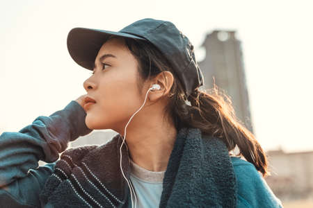 Sport health in earphone to listen music between workout at sport stadium.の写真素材