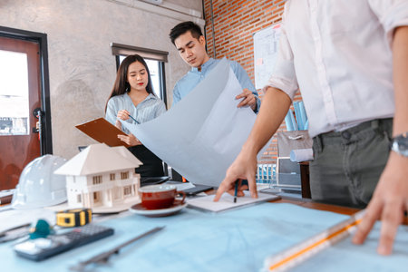 industry manager and engineer, businessman reading and checking blueprint, drawing  in the room