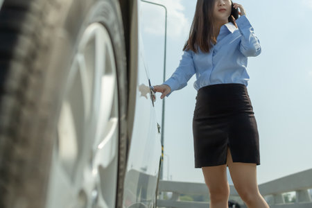 Close up of hand businesswoman opening a car door and call by phone.の写真素材