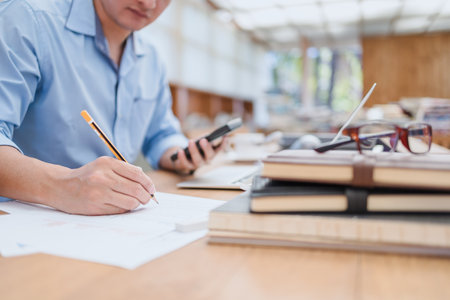 businessman using pencil checking document data calculator for calculate budget accountancy. finance and accounting conceptの写真素材