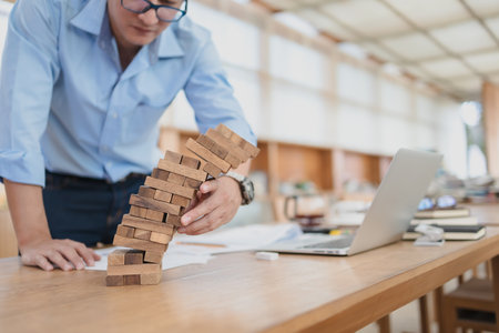 Abstract businessmen fail danger tower block game building construction protect plan and project control.の写真素材