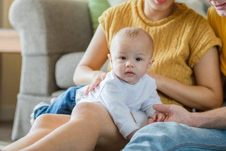 happy mother, father with baby playing together at home. Family, parent and baby concept.