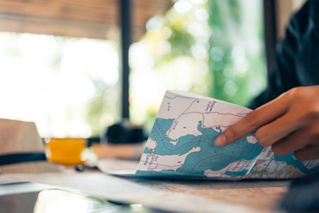 Tourist planning vacation with map and other travel accessories on the table. Travel, holiday, vocation concept.の写真素材