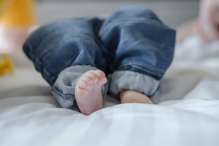 cute baby sleeping in bed at home. family love concept.の写真素材