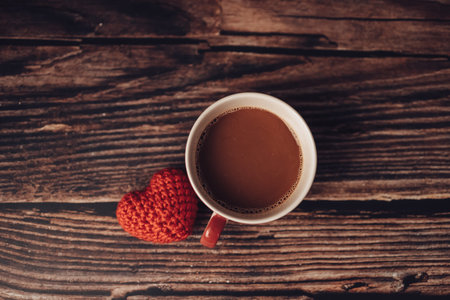 heart shape and coffee on wood table.