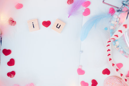 wooden letter block on a book. feather, heart shape and light decorative in box present. Love, Valentine and holiday concept.の写真素材