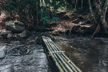 Bamboo bridge cross the water in waterfall.  Nature and relax time concept.の写真素材
