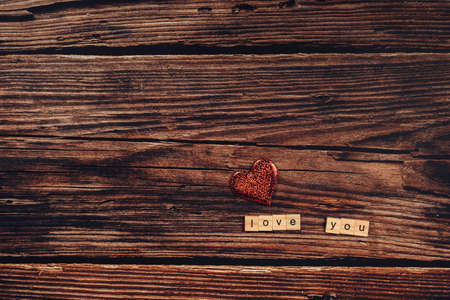 wooden letter block word "Love you" and heart shape on wood table background. Present and gift concept.の写真素材