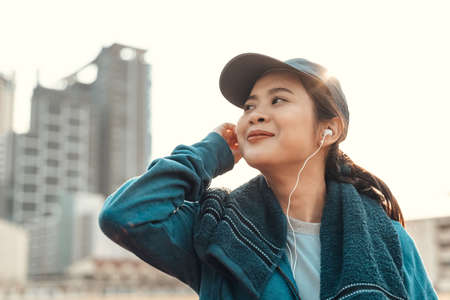 Sport health in earphone to listen music between workout at sport stadium.の写真素材