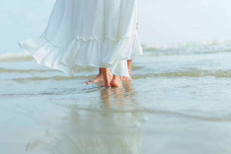 foot of romantic time loving couple dance on the beach. Love travel concept. Honeymoon concept.の写真素材
