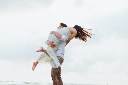 romantic couple hug together on the beach at summer. Honeymoon, travel, holiday, summer concept.の写真素材