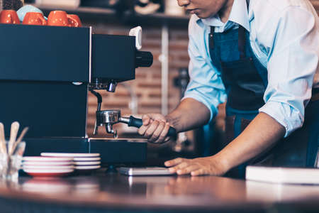 Barista cafe making coffee with coffee machine. Coffee preparation service concept.の写真素材