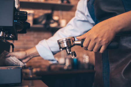 Barista cafe making coffee with coffee machine. Coffee preparation service concept.の写真素材