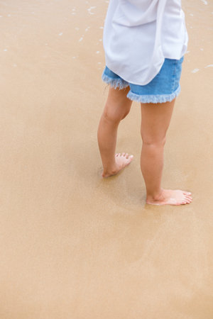 Happy young girl walking on the beach. Summer travel, vocation, holiday concept.