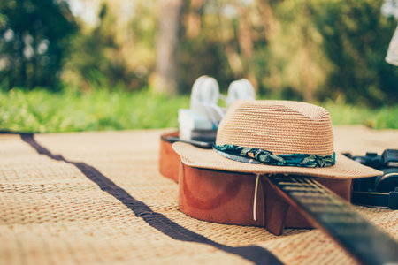 Headphone, hat, book and phone on guitar. Object picnic concept.の写真素材