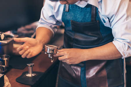 Barista cafe making coffee with coffee machine. Coffee preparation service concept.の写真素材