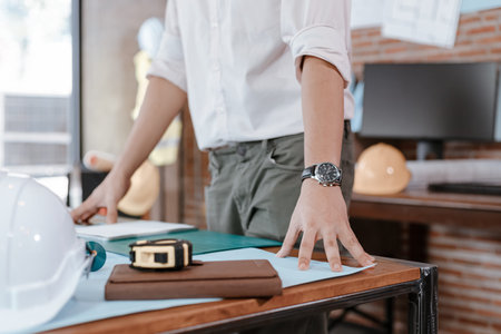 industry manager, engineer, businessman reading and checking blueprint, drawing plan in the room in...