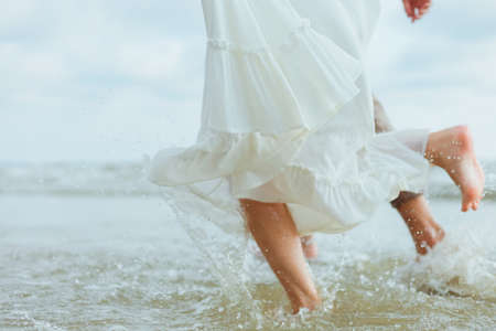 Love young couple running on the beach. Holiday and vocation concept.の写真素材