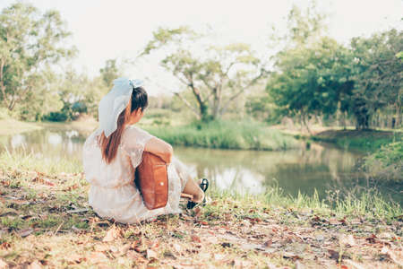 Girl playing guitar in the forest. Music hobby and picnic concept.の写真素材