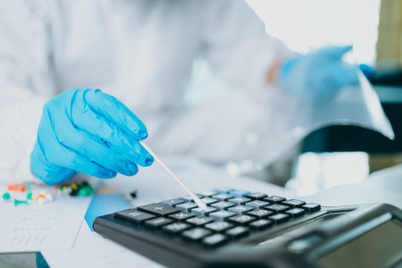 Scientists use Cotton Bat for keep and checking and testing virus on labtop at home.