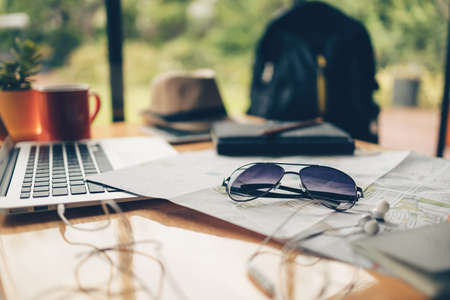 sun glassess and other travel accessories around on the table. Vocation, travel, holidays and backpack concept.の写真素材