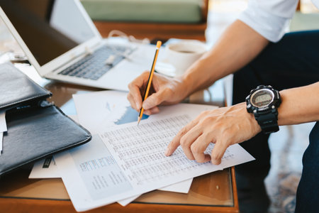 Administrator businessman making report, calculating balance. Business analyzing income charts,...