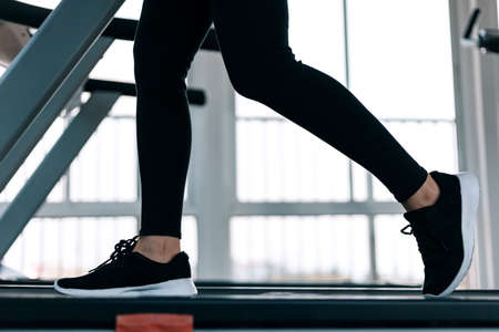 Fitness women running on track treadmill, exercise fitness. Fitness, gym, workout and lifestyle concept.の写真素材