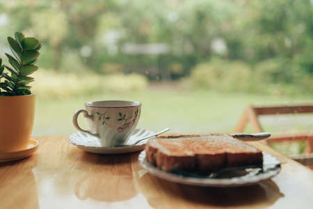 Plate with toasted bread on the wood table. Coffee and dessert concept.の写真素材
