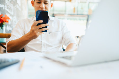 young businessman working and using smart phone and notebook computer in workplace.Young freelance...