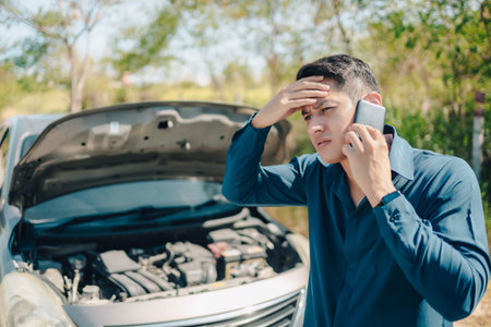 young man calling,  texting for car service on roadside assistance after broken car. Car broken, car...