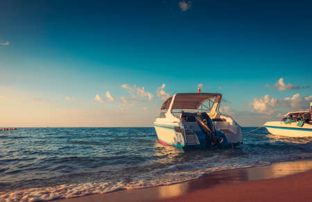 Speed boat at the sea beach and sunset.の写真素材